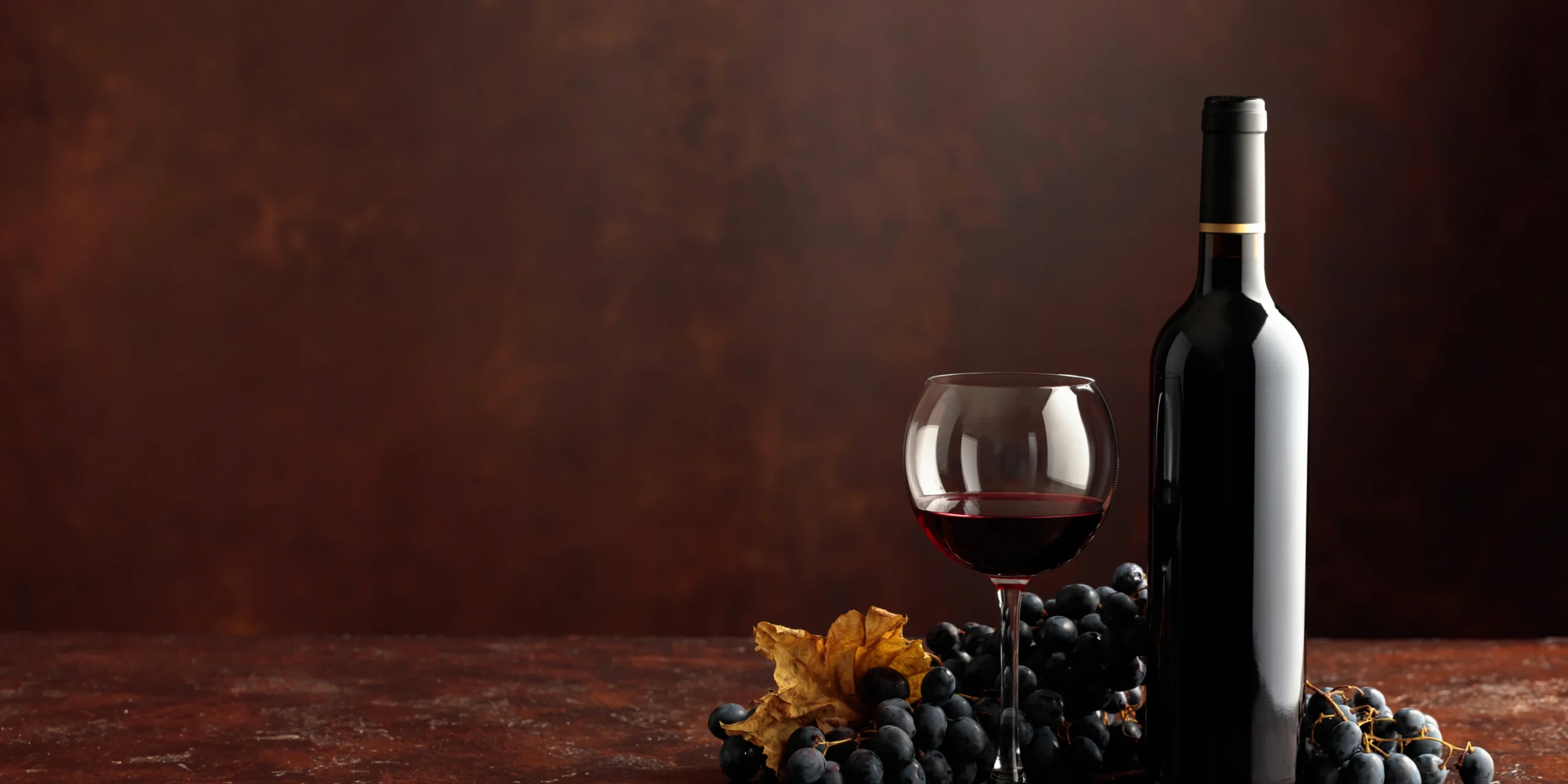 Wine bottle and glass with grapes